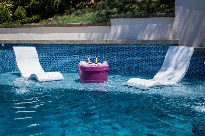 Modern pool shape with armchairs 