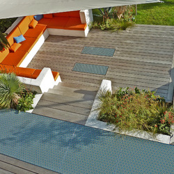 A wooden terrace dresses a garden with elegance.